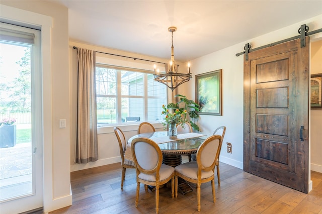 128 Antler Peak Ln, Kalispell, MT 59901 - dining space featuring light wood-style floors, a chandelier, and a barn door