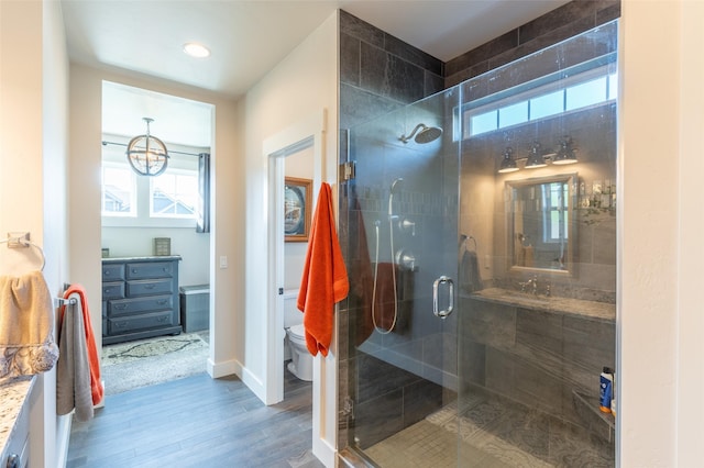 128 Antler Peak Ln, Kalispell, MT 59901 - bathroom with vanity, wood finished floors, a shower stall, healthy amount of natural light, and recessed lighting