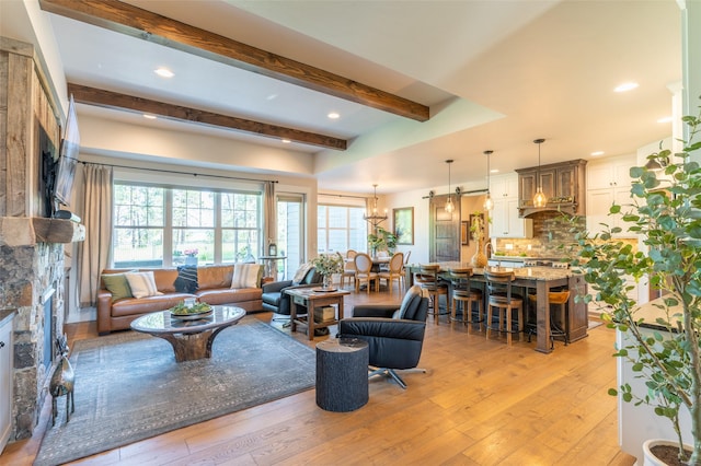 128 Antler Peak Ln, Kalispell, MT 59901 - living room featuring light wood finished floors, beam ceiling, plenty of natural light, a chandelier, and recessed lighting