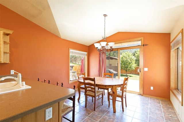 1585 Stanley St, Missoula, MT 59802 - dining room with healthy amount of natural light, vaulted ceiling, a chandelier, and tile patterned floors