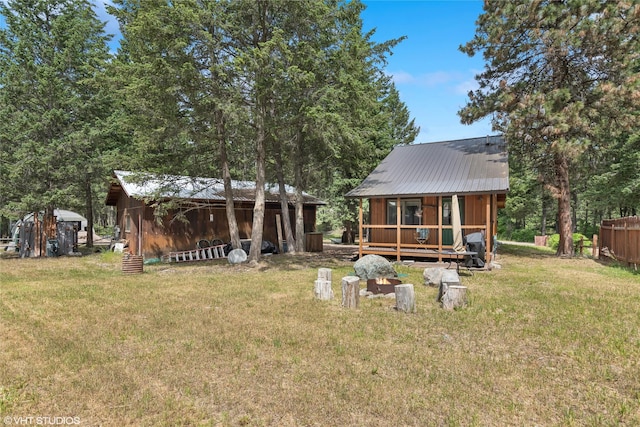 34045 Redgate Dr, Bigfork, MT 59911 - back of house with a lawn, a metal roof, and an outdoor structure