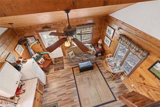34045 Redgate Dr, Bigfork, MT 59911 - unfurnished living room featuring wood walls, wood finished floors, wood ceiling, and ceiling fan