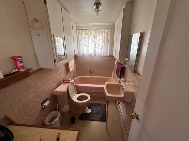 521 N Central Ave, Ekalaka, MT 59324 - full bath with tile walls, a garden tub, and a wainscoted wall