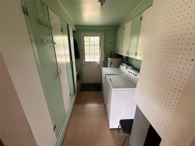 521 N Central Ave, Ekalaka, MT 59324 - washroom with cabinet space, washing machine and clothes dryer, water heater, and parquet flooring