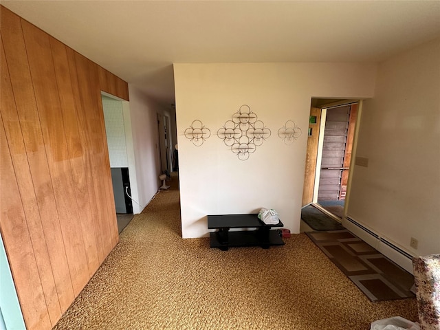 521 N Central Ave, Ekalaka, MT 59324 - corridor with baseboard heating, wood walls, and carpet floors