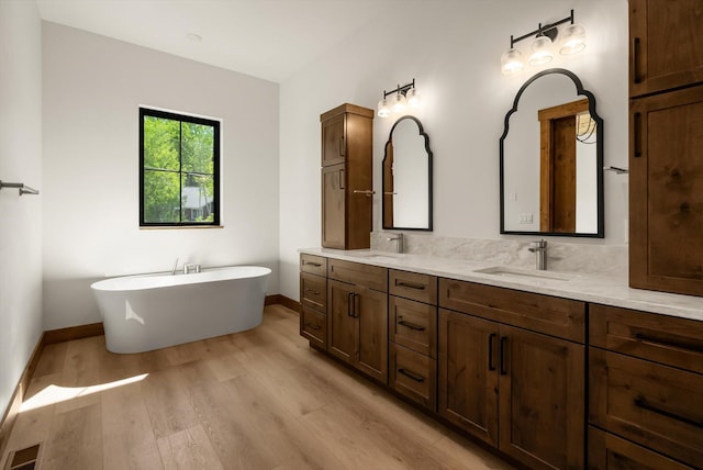 508 Dakota Ave, Whitefish, MT 59937 - bathroom featuring double vanity, wood finished floors, and a freestanding bath