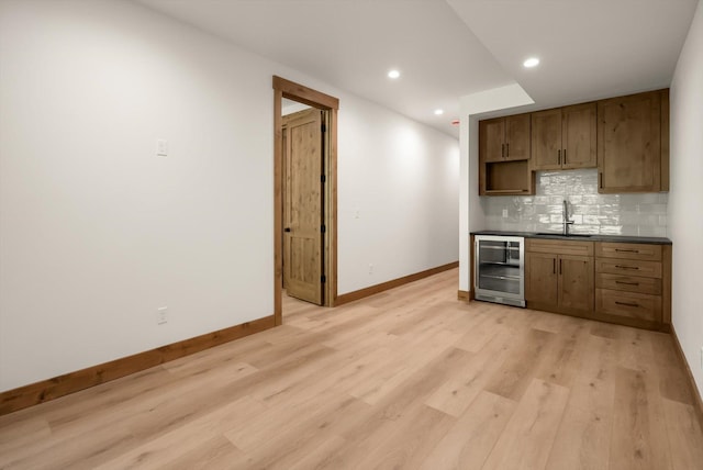 508 Dakota Ave, Whitefish, MT 59937 - kitchen featuring beverage cooler, dark countertops, decorative backsplash, light wood-style floors, and recessed lighting