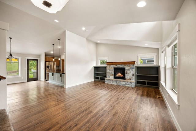 150 Swede Trl, Kalispell, MT 59901 - unfurnished living room featuring dark wood-type flooring, vaulted ceiling, recessed lighting, and a fireplace