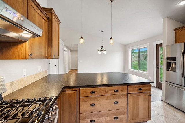 150 Swede Trl, Kalispell, MT 59901 - kitchen with stainless steel appliances, ventilation hood, a peninsula, dark countertops, and brown cabinetry