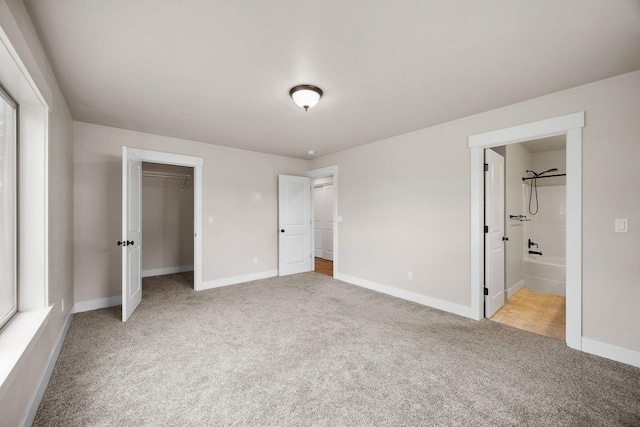 150 Swede Trl, Kalispell, MT 59901 - unfurnished bedroom featuring carpet floors, ensuite bath, and a closet