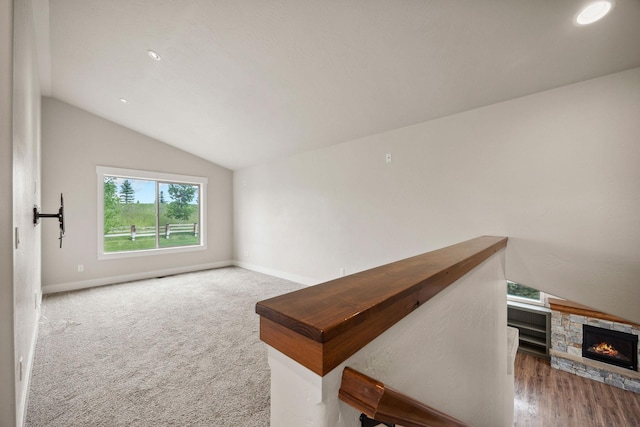 150 Swede Trl, Kalispell, MT 59901 - unfurnished room featuring vaulted ceiling, a fireplace, recessed lighting, and carpet