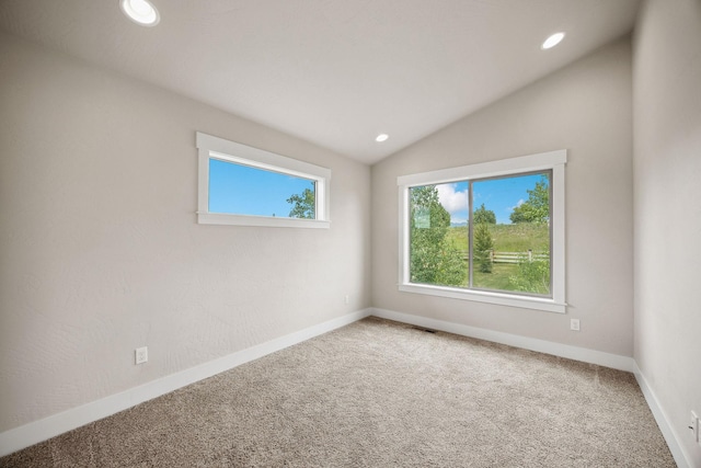150 Swede Trl, Kalispell, MT 59901 - spare room featuring recessed lighting, carpet flooring, and lofted ceiling