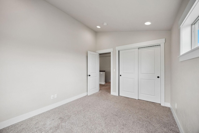 150 Swede Trl, Kalispell, MT 59901 - unfurnished bedroom with carpet floors, lofted ceiling, recessed lighting, and a closet
