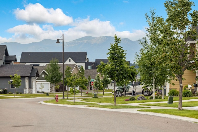 150 Swede Trl, Kalispell, MT 59901 - view of asphalt road featuring sidewalks, street lighting, a mountain view, and a residential view