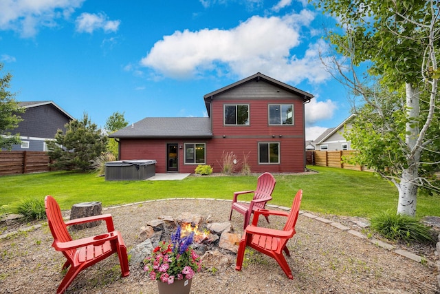 150 Swede Trl, Kalispell, MT 59901 - back of house with a hot tub, a fire pit, and a patio area