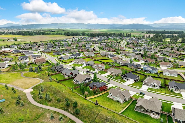 150 Swede Trl, Kalispell, MT 59901 - aerial view of property and surrounding area featuring a mountain backdrop and nearby suburban area