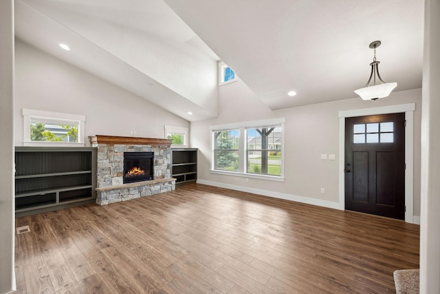 150 Swede Trl, Kalispell, MT 59901 - unfurnished living room featuring wood finished floors, a fireplace, recessed lighting, and high vaulted ceiling