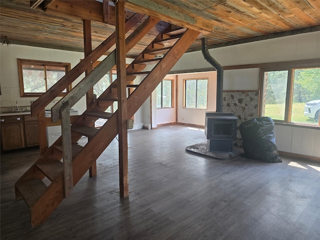 40 Larch Ln, Saint Regis, MT 59866 - unfurnished living room featuring a wood stove, dark wood-type flooring, stairway, and wood ceiling
