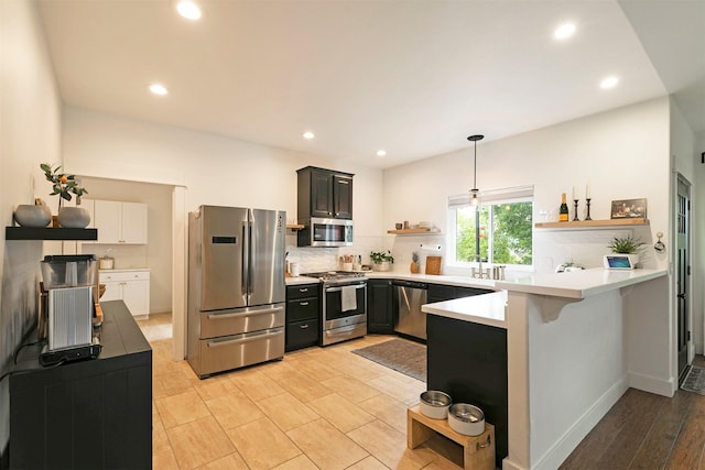 15660 Sara Jo Ln, Frenchtown, MT 59834 - kitchen featuring stainless steel appliances, open shelves, a peninsula, decorative backsplash, and recessed lighting