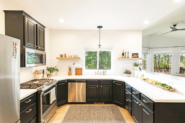 15660 Sara Jo Ln, Frenchtown, MT 59834 - kitchen featuring appliances with stainless steel finishes, open shelves, decorative backsplash, recessed lighting, and light countertops
