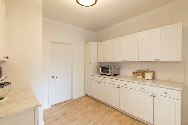 15660 Sara Jo Ln, Frenchtown, MT 59834 - kitchen with white cabinets, light stone counters, and light wood-style flooring