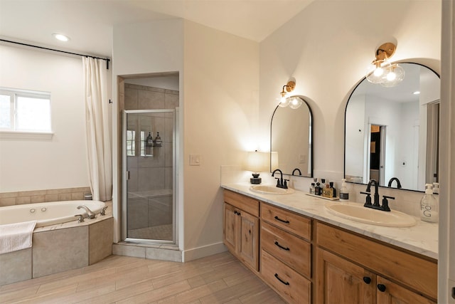 15660 Sara Jo Ln, Frenchtown, MT 59834 - bathroom featuring a shower stall, a garden tub, double vanity, and wood finished floors
