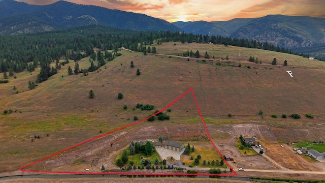 15660 Sara Jo Ln, Frenchtown, MT 59834 - aerial view of sparsely populated area with property boundaries highlighted and a mountain backdrop