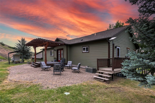 15660 Sara Jo Ln, Frenchtown, MT 59834 - back of house at dusk featuring a pergola, a deck, a yard, and a patio area