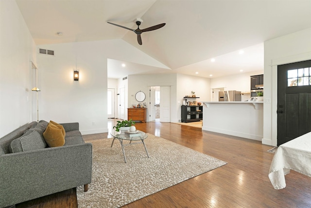 15660 Sara Jo Ln, Frenchtown, MT 59834 - living area featuring ceiling fan, wood finished floors, vaulted ceiling, and healthy amount of natural light