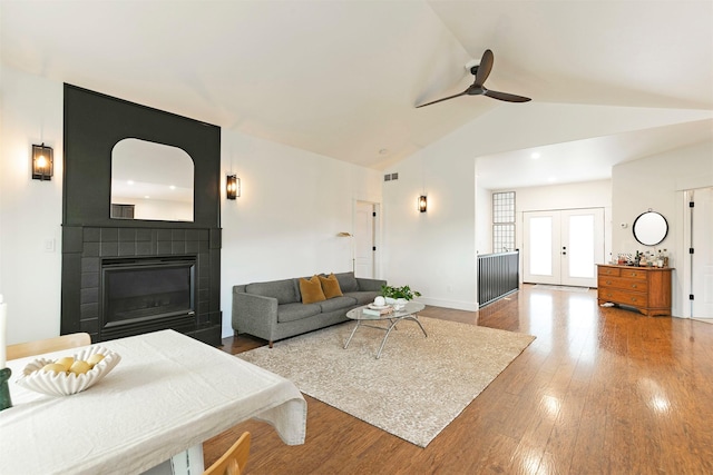 15660 Sara Jo Ln, Frenchtown, MT 59834 - living room with a ceiling fan, wood finished floors, a glass covered fireplace, french doors, and high vaulted ceiling