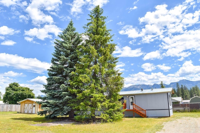 36240 Felsman St, Pablo, MT 59855 - rear view of property with a mountain view, a storage unit, and a metal roof