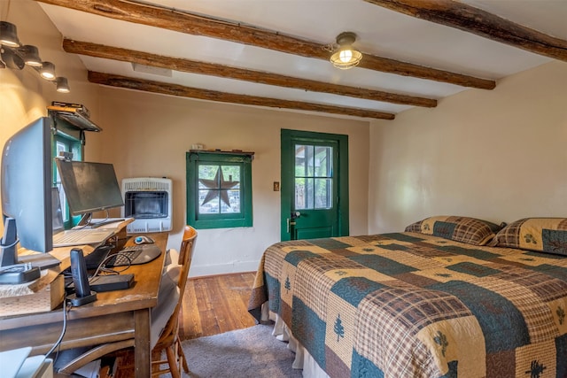 3422 Rimini Rd, Helena, MT 59601 - bedroom with heating unit, beamed ceiling, wood finished floors, and a desk