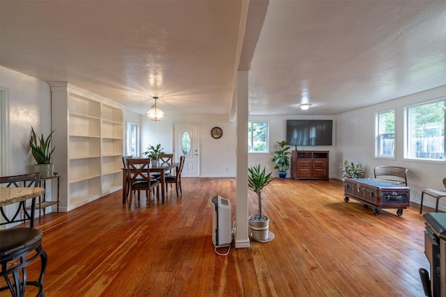 3422 Rimini Rd, Helena, MT 59601 - living room featuring wood-type flooring, built in features, and a chandelier