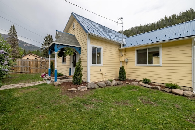 3422 Rimini Rd, Helena, MT 59601 - rear view of house with a metal roof and a mountain view