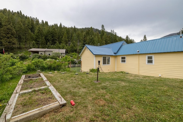 3422 Rimini Rd, Helena, MT 59601 - view of yard with a wooded view and a vegetable garden