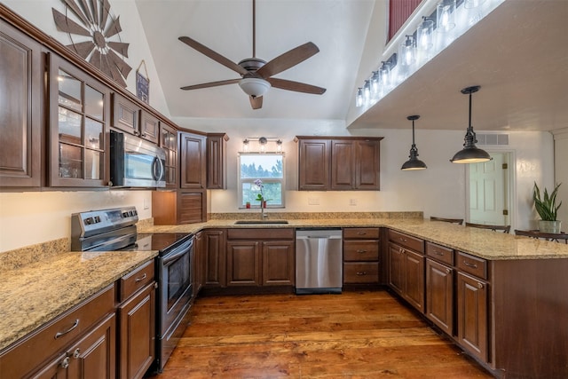 3422 Rimini Rd, Helena, MT 59601 - kitchen featuring stainless steel appliances, a ceiling fan, dark wood-type flooring, a peninsula, and high vaulted ceiling