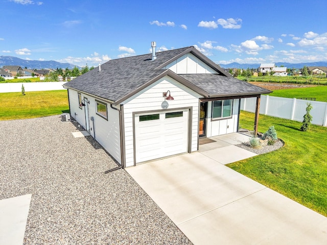 915 Stewart Loop, Bozeman, MT 59718 - view of front of home with roof with shingles, board and batten siding, a mountain view, driveway, and an attached garage