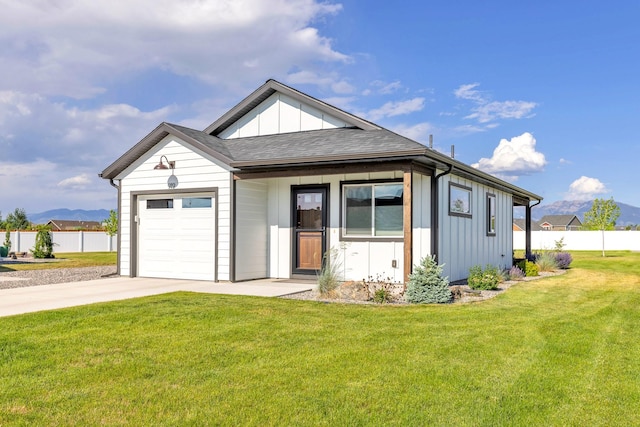 915 Stewart Loop, Bozeman, MT 59718 - view of front of house with board and batten siding, an attached garage, driveway, and a shingled roof