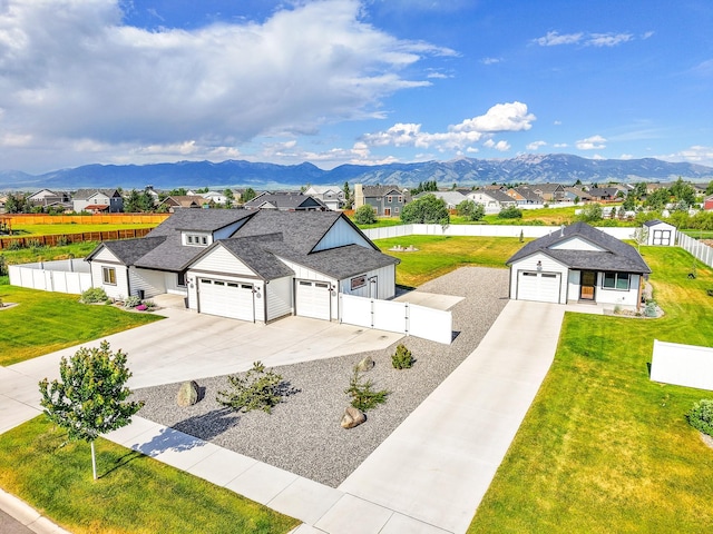 915 Stewart Loop, Bozeman, MT 59718 - view of front of house with concrete driveway, a residential view, a gate, and an attached garage