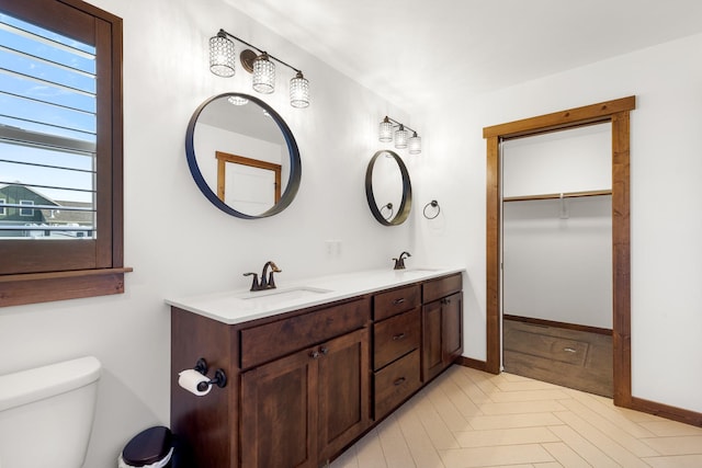 915 Stewart Loop, Bozeman, MT 59718 - full bath featuring double vanity, plenty of natural light, a spacious closet, and tile patterned flooring