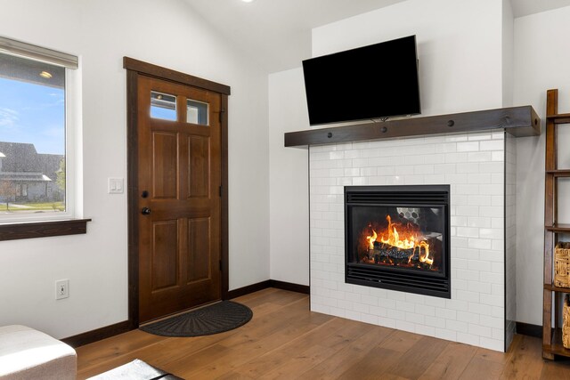915 Stewart Loop, Bozeman, MT 59718 - entrance foyer with vaulted ceiling, wood finished floors, and a brick fireplace
