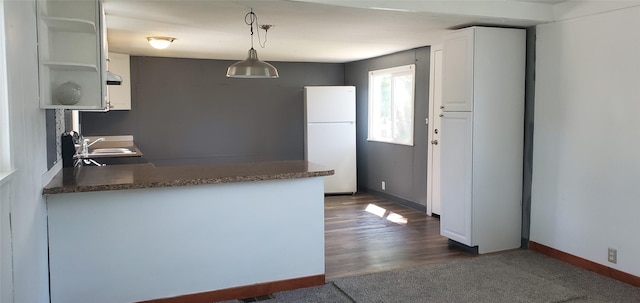 1805 Joslyn St Unit 25, Helena, MT 59601 - kitchen with freestanding refrigerator, a peninsula, white cabinets, open shelves, and extractor fan