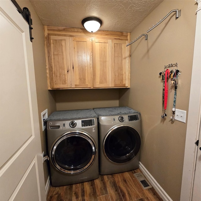 104 39th Ave NE, Great Falls, MT 59404 - laundry room featuring cabinet space, washer and clothes dryer, dark wood-style flooring, and a textured ceiling