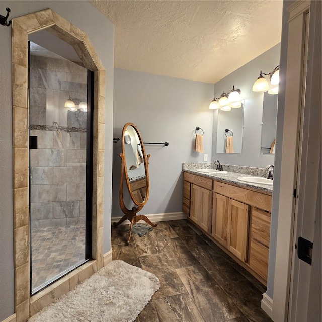 104 39th Ave NE, Great Falls, MT 59404 - bathroom featuring marble finish floors, a stall shower, double vanity, and a textured ceiling
