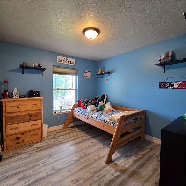 104 39th Ave NE, Great Falls, MT 59404 - bedroom featuring a textured ceiling and wood finished floors