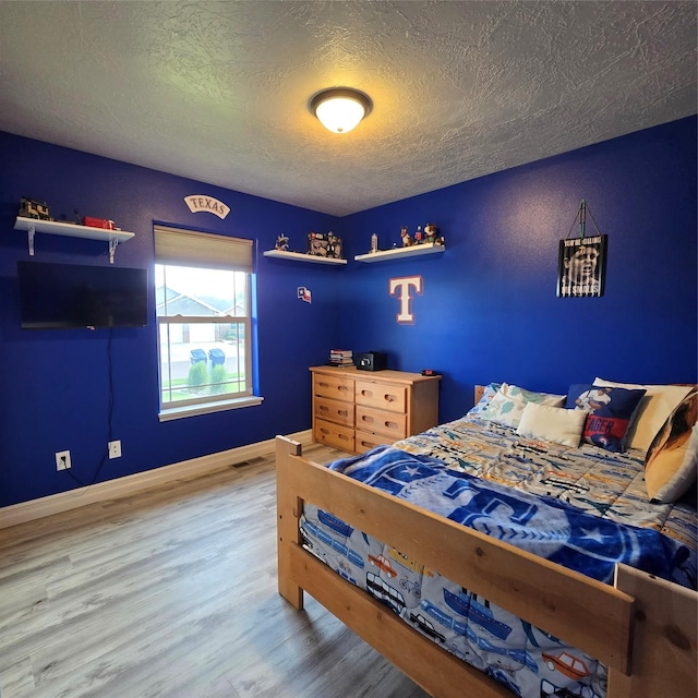 104 39th Ave NE, Great Falls, MT 59404 - bedroom featuring wood finished floors and a textured ceiling