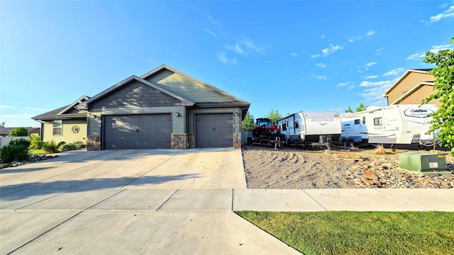 104 39th Ave NE, Great Falls, MT 59404 - view of front of home with a garage, stone siding, and driveway