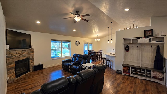 104 39th Ave NE, Great Falls, MT 59404 - living area featuring vaulted ceiling, a ceiling fan, a stone fireplace, wood finished floors, and recessed lighting