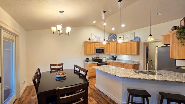 104 39th Ave NE, Great Falls, MT 59404 - kitchen with stainless steel appliances, a peninsula, dark wood-type flooring, vaulted ceiling, and a chandelier