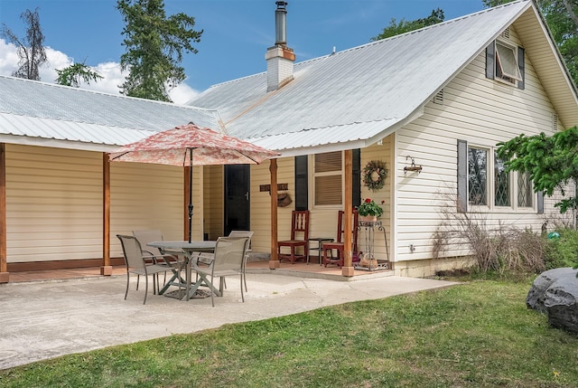 429 Pleasant Valley Rd, Marion, MT 59925 - rear view of house featuring a metal roof, a patio area, and a yard
